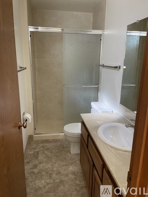 A bathroom with a toilet, sink, and shower.