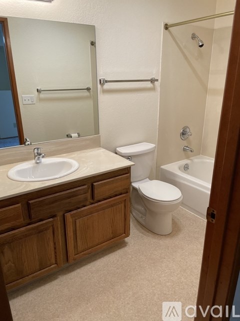 A bathroom with a sink, toilet and bathtub.