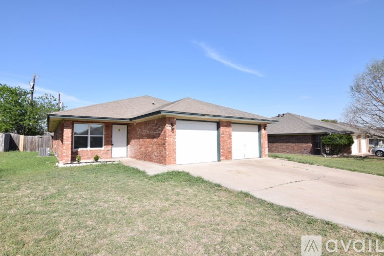A house with a garage and a driveway is for sale.