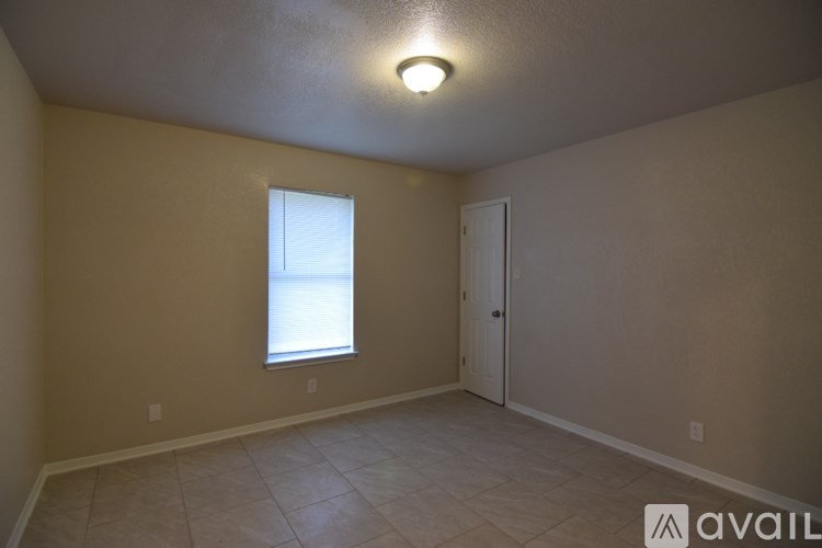 A room with a window and a door is available for rent.