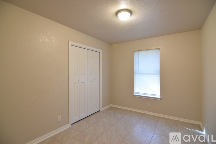 A room with a white door and a window with a white frame.