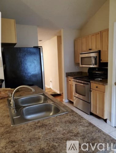 A kitchen with granite countertops and stainless steel appliances.