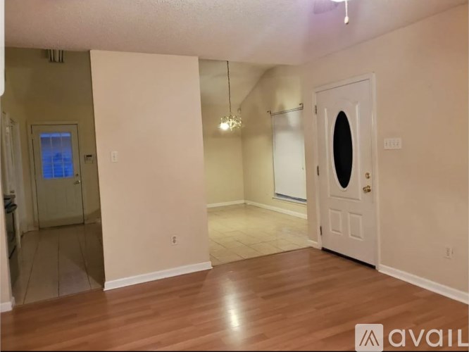 A room with a door on the right and a window on the left.
