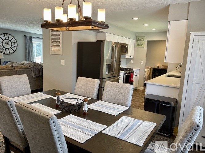 A dining room with a table set for four.