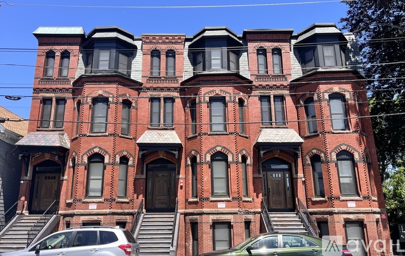 A red brick building with multiple windows and doors.