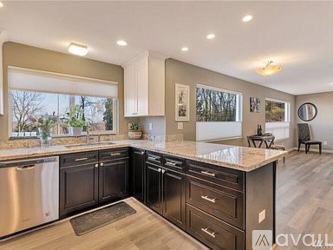 A kitchen with a large island and stainless steel appliances.