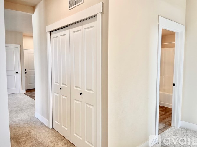 A white double door closet in a room.