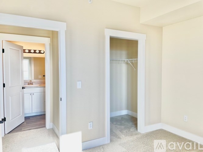 A room with a white door and a white chair.
