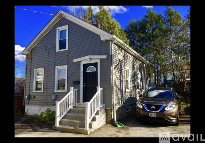 A house with a car parked in front.