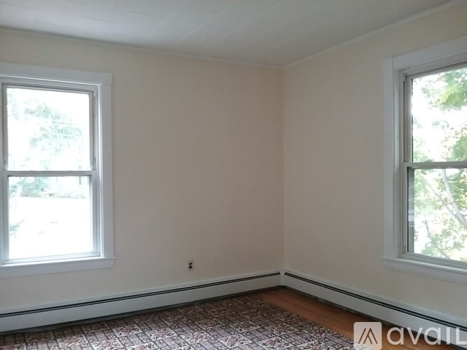 A room with two windows and a tiled floor.
