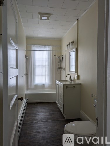 A bathroom with a toilet, sink, and bathtub.