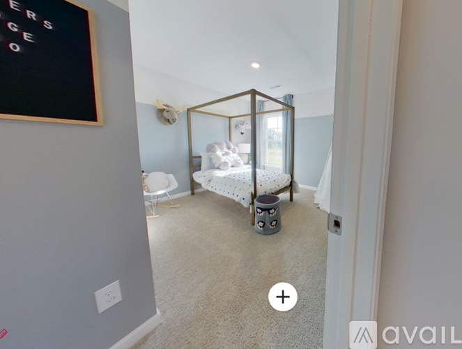 A bedroom with a bed and a chair in it.