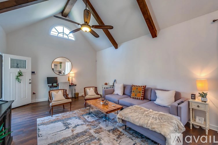 A living room with a grey couch and a wooden coffee table.