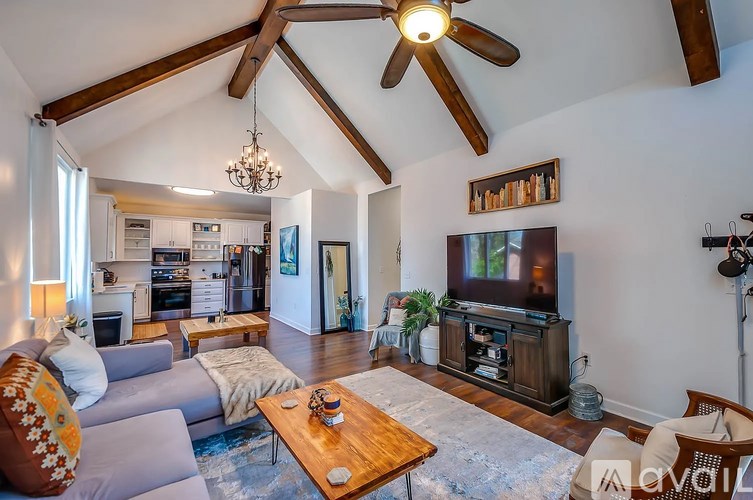A living room with a grey couch and a wooden coffee table.