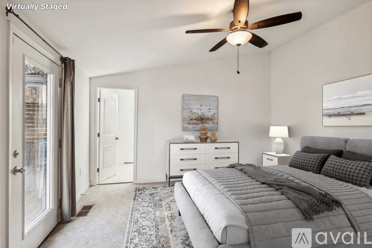 A bedroom with a bed, dresser, and ceiling fan.