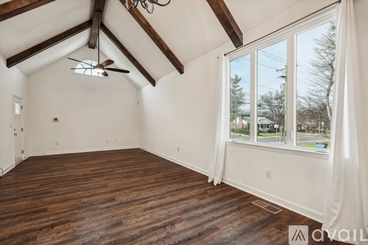 A room with wooden floors and a ceiling fan.