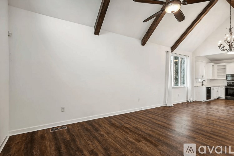 A room with wooden floors and a ceiling fan.