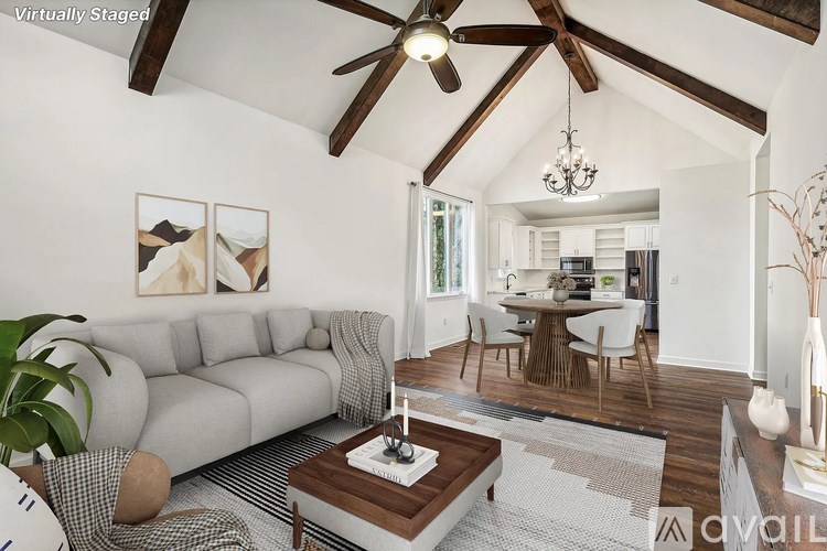 A living room with a grey sofa and a wooden coffee table.