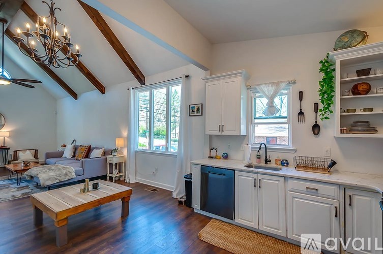 A kitchen with a wooden table and a chandelier.