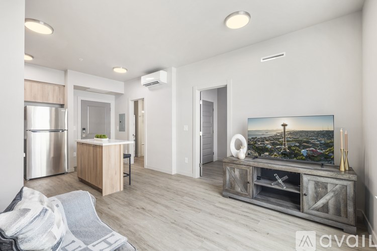 A modern kitchen with a wooden island and a television displaying a cityscape.