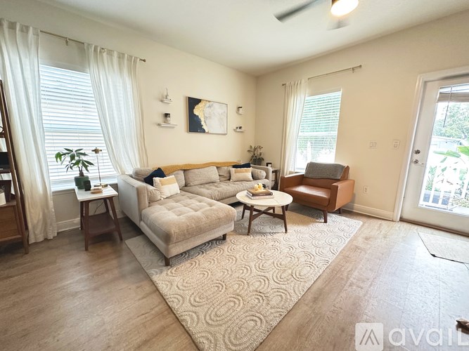 A living room with a couch, chair, and table.