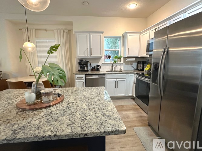 A kitchen with granite countertops and stainless steel appliances.