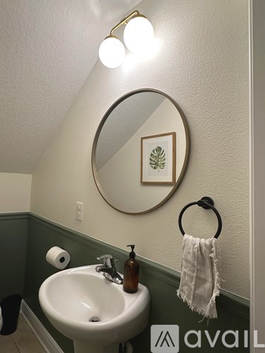 A bathroom with a white sink and a mirror above it.