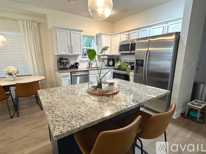 A kitchen with granite countertops and stainless steel appliances.