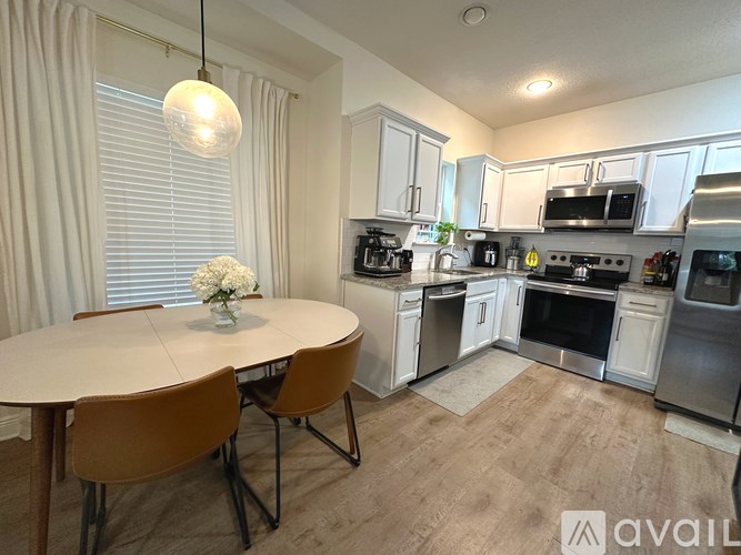 A modern kitchen with a dining table and chairs.