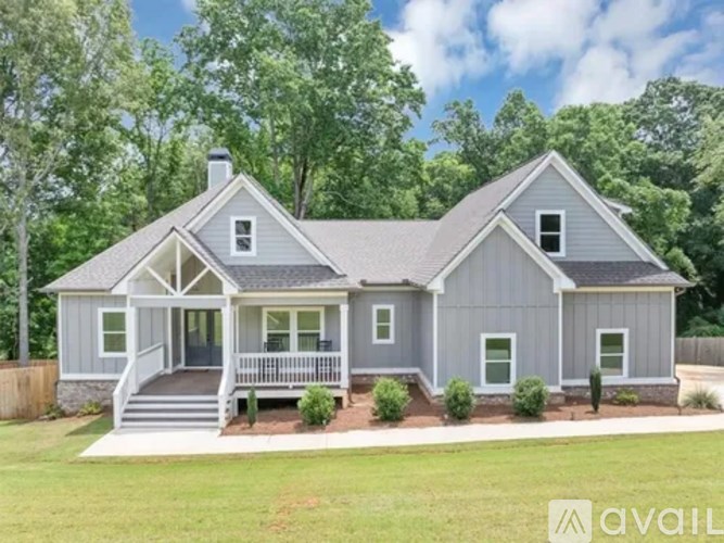 A house with a grey exterior and a white porch.