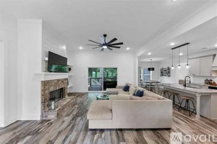 A modern living room with a fireplace and a television.