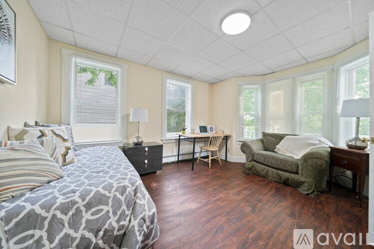 A bedroom with a large bed and a couch.