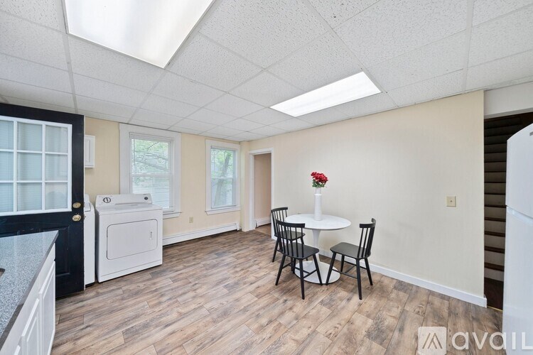 A kitchen area with a dining table and chairs.