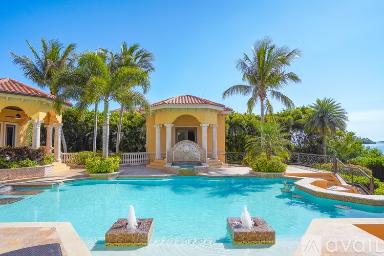 A large house with a pool in front of it.