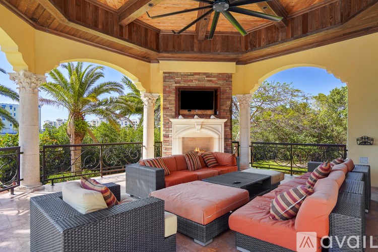 A patio with a fireplace and furniture is available for rent.