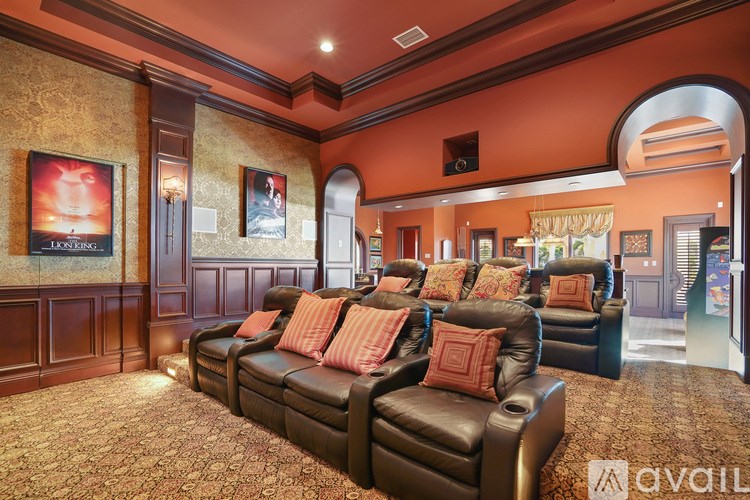 A living room with a couch and a poster of a movie.