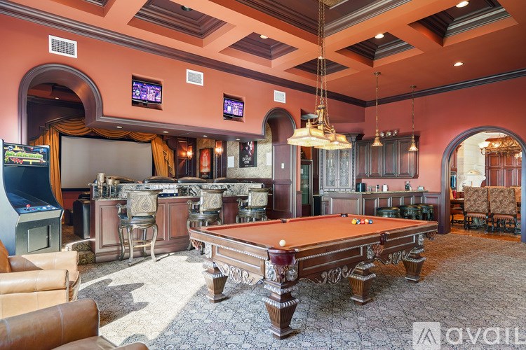 A room with a pool table and a TV.