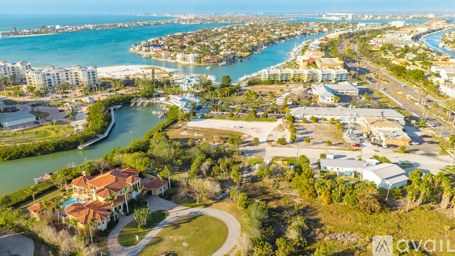 A bird's eye view of a coastal residential area with a river running through it.