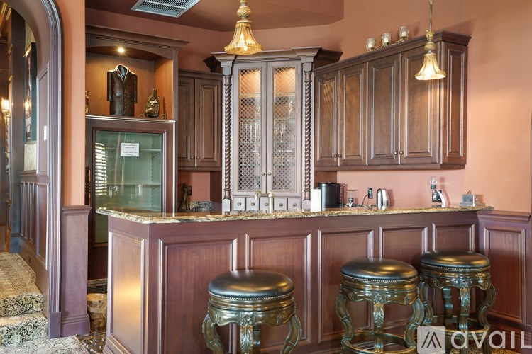 A bar area with a counter and stools.