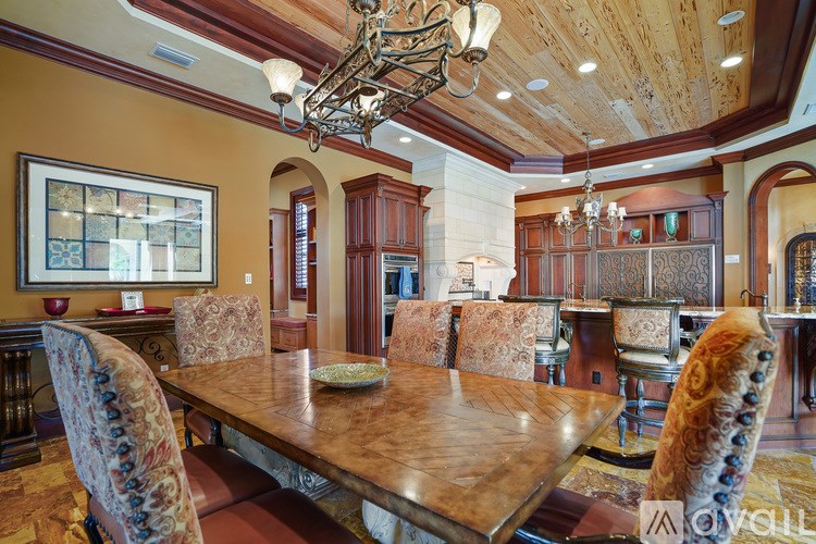 A large dining room with a wooden table and chairs.