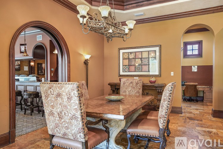 A dining room with a table and chairs.