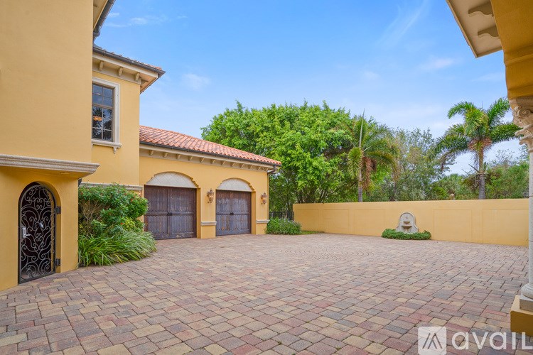 A house with a driveway and a gate.