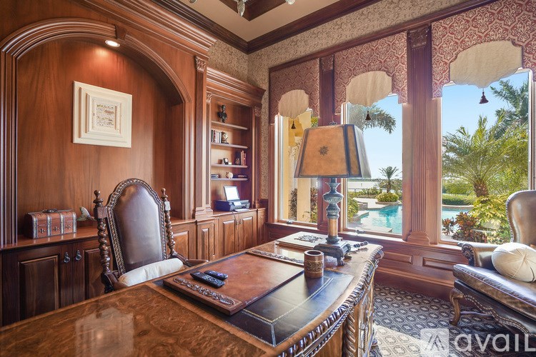 A room with a desk and a chair in front of a window.