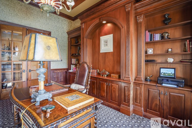 A room with a wooden desk and a chair.