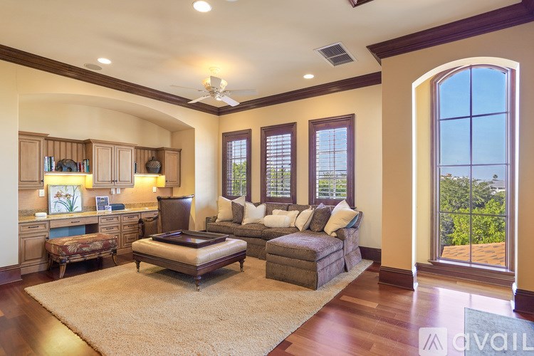 A living room with a couch, a chair, and a rug.
