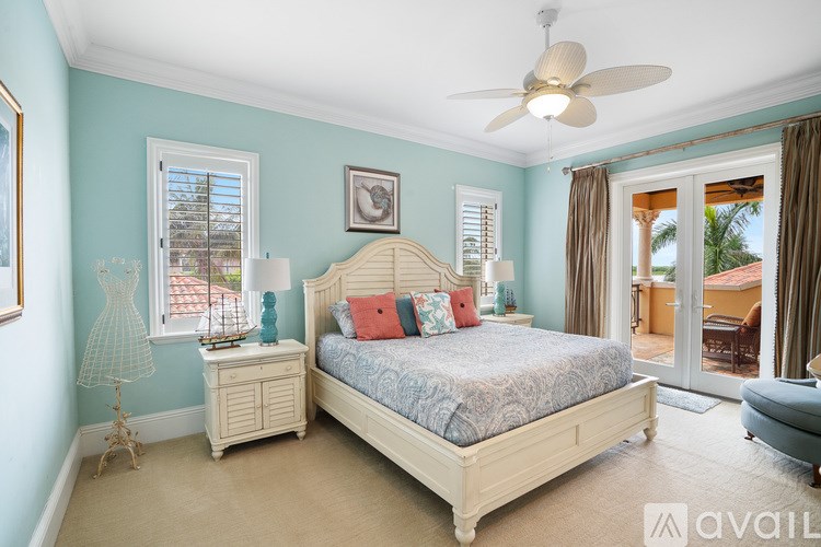 A bedroom with a bed, dresser, and window.