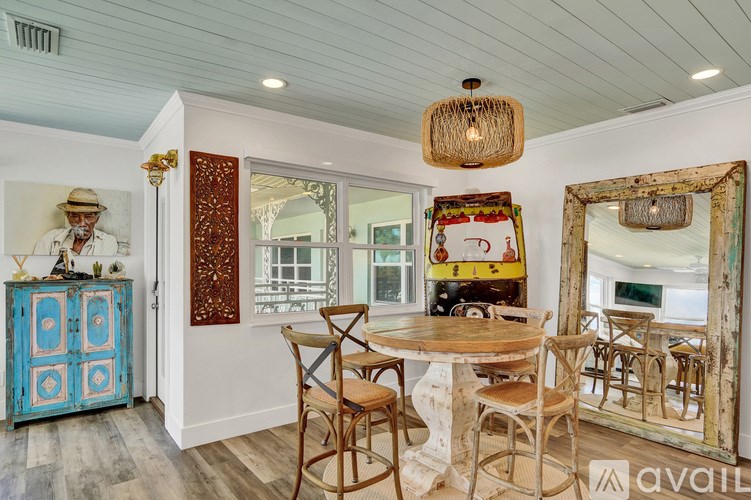 A dining room with a wooden table and chairs.