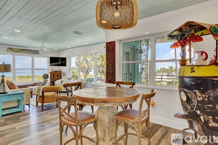 A dining room with a wooden table and chairs.