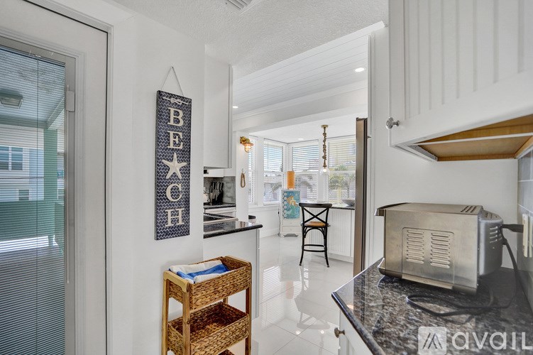 A kitchen with a toaster on the counter.