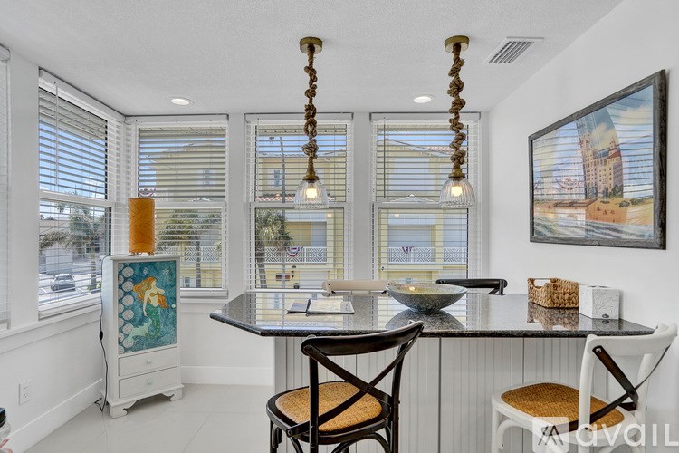 A kitchen with a table and chairs and a window.